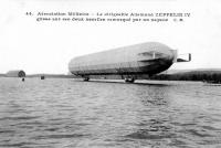 carte postale ancienne de Dirigeables Le dirigeable Allemand Zeppelin IV glisse sur ses deeux nacelles remorqué par un vapeur